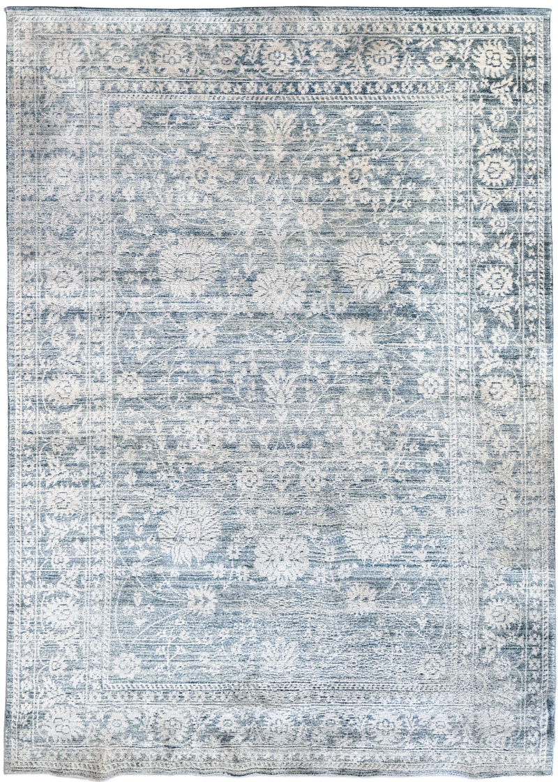 The same light blue area rug looking clean and vibrant with its pattern fully restored after expert cleaning at Wooden Looms.